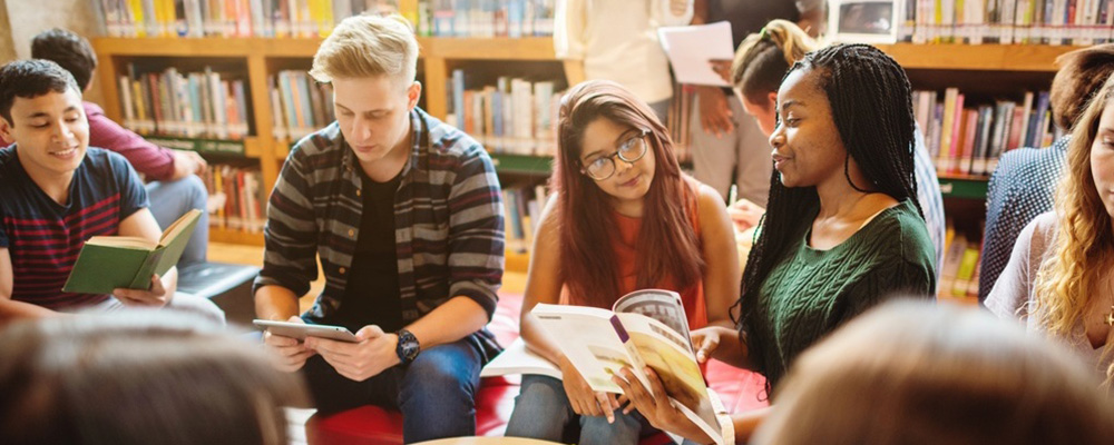 Teenagers reading in school library