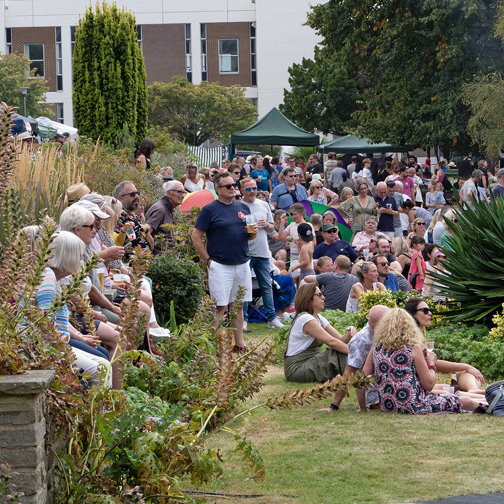 Pippfest 2024 audience listening to live music in the beautiful grounds of Pippbrook House