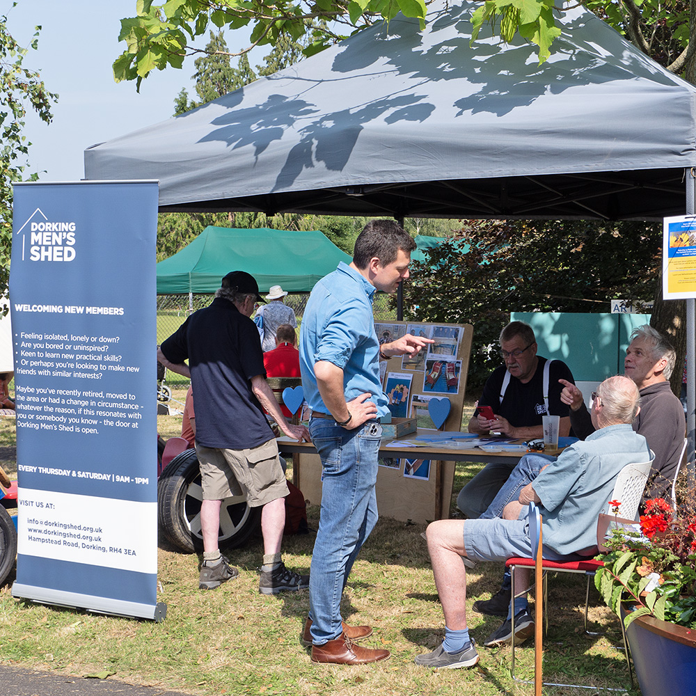 MP Chris Coughlan at Dorking Men's Shed stall during Pippfest 2024